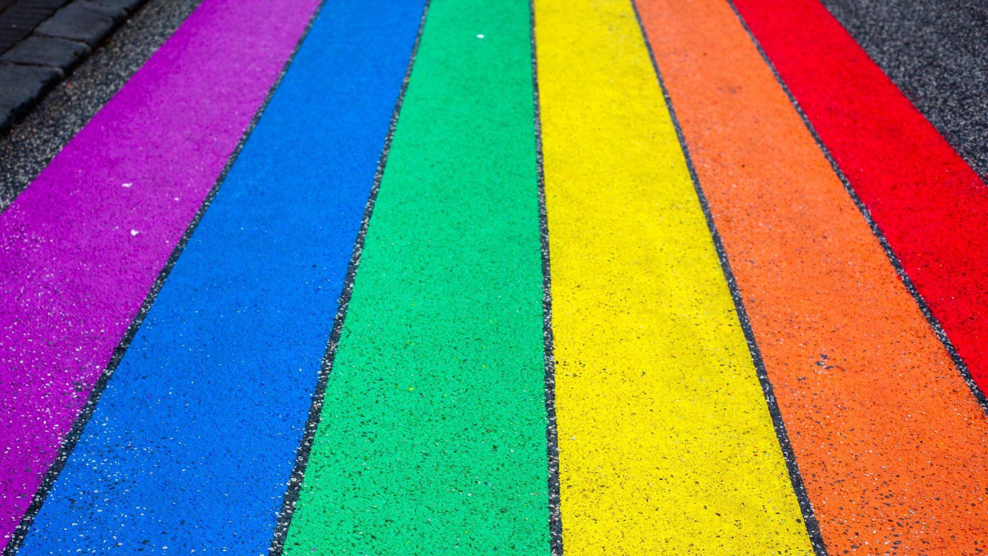 Photograph of rainbow stripes painted on asphalt