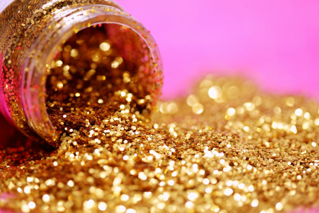 Small pot of gold glitter on its side