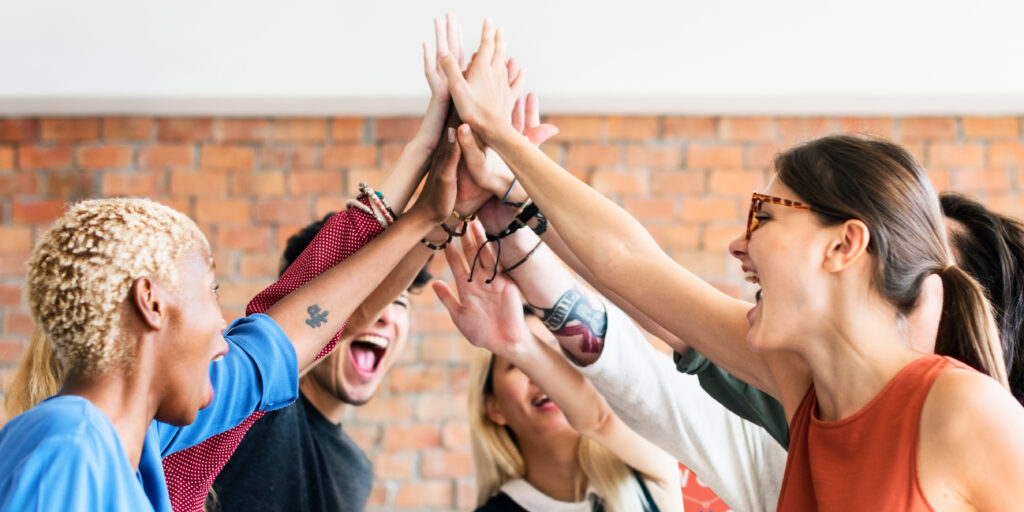 Group of coworkers all high-fiving each other
