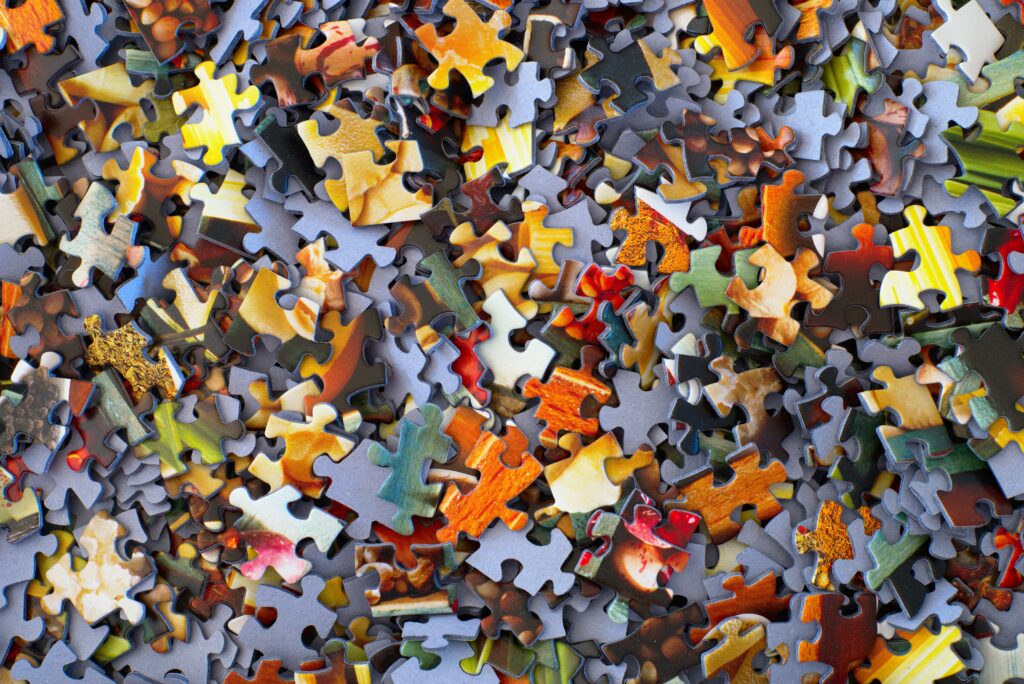 Jigsaw puzzle pieces spread out across a surface
