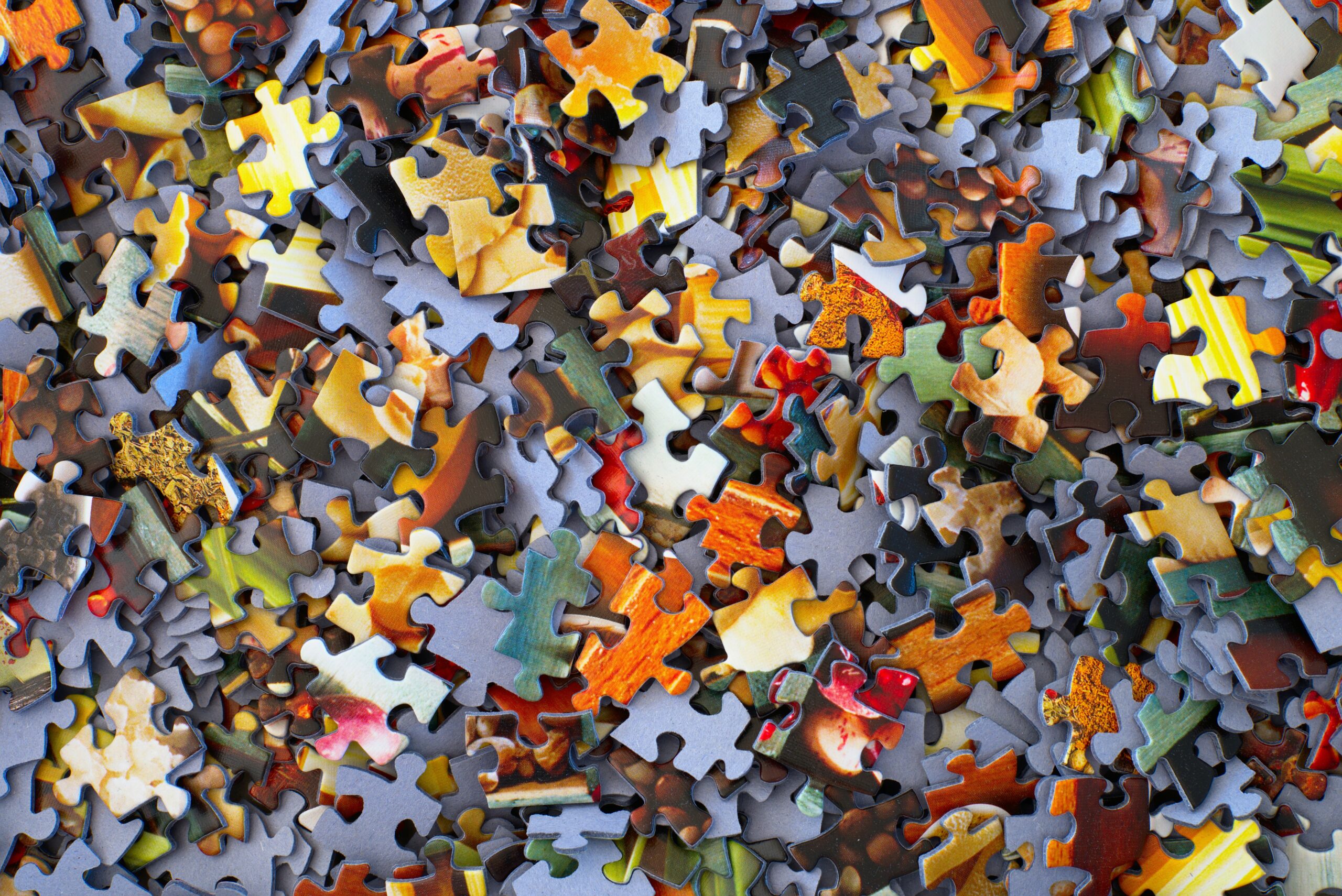 Jigsaw puzzle pieces spread out across a surface