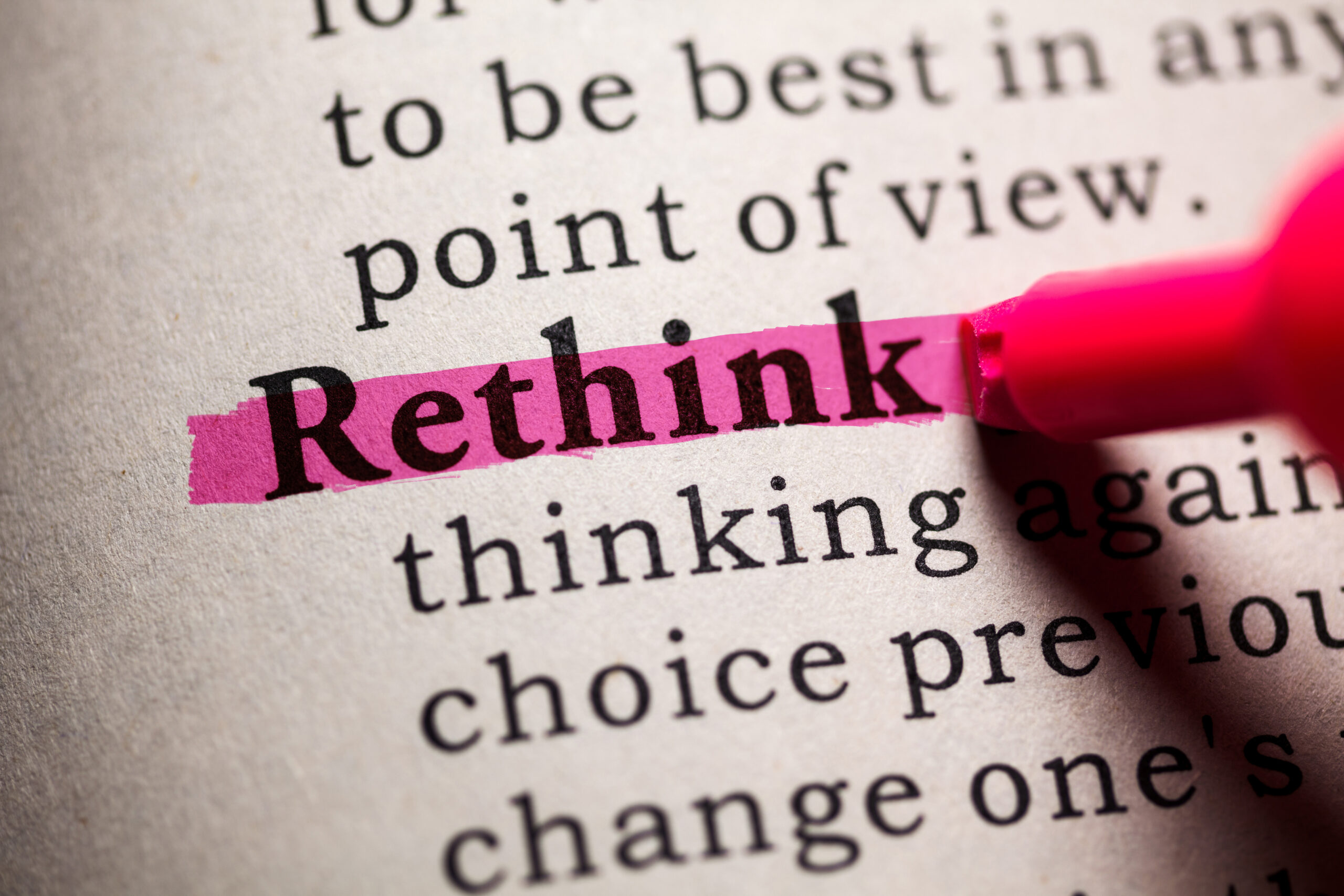 Closeup of a dictionary page where the work "Rethink" is highlighted in pink.