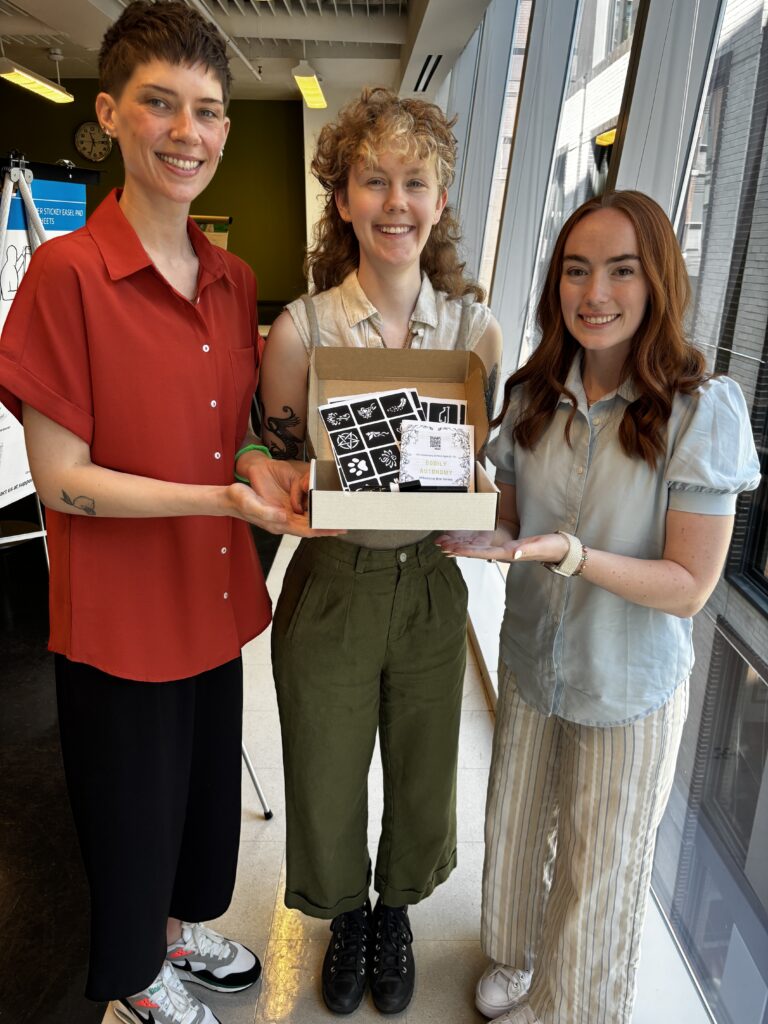 The CodED team holds a prototype of their Milestone Box.