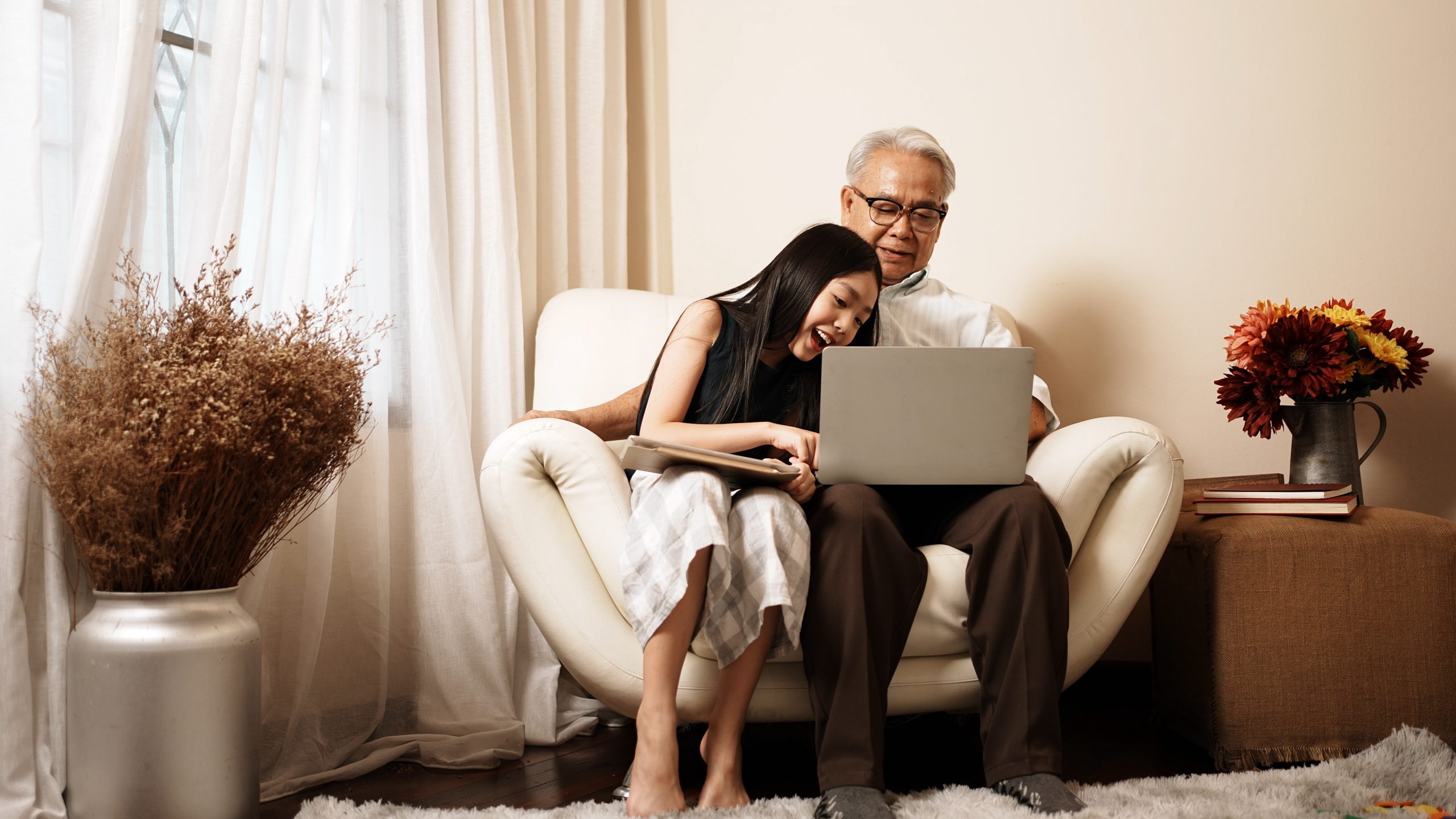 Asian grandpa and granddaughter are using gadgets playing on lap Image of computer screen, logged into WordPress, with backend screen to create a new post.