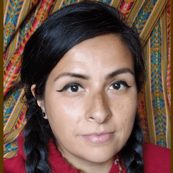 Photo of liliana cabrera looking at the camera from the shoulders up with dark hair in two braids.