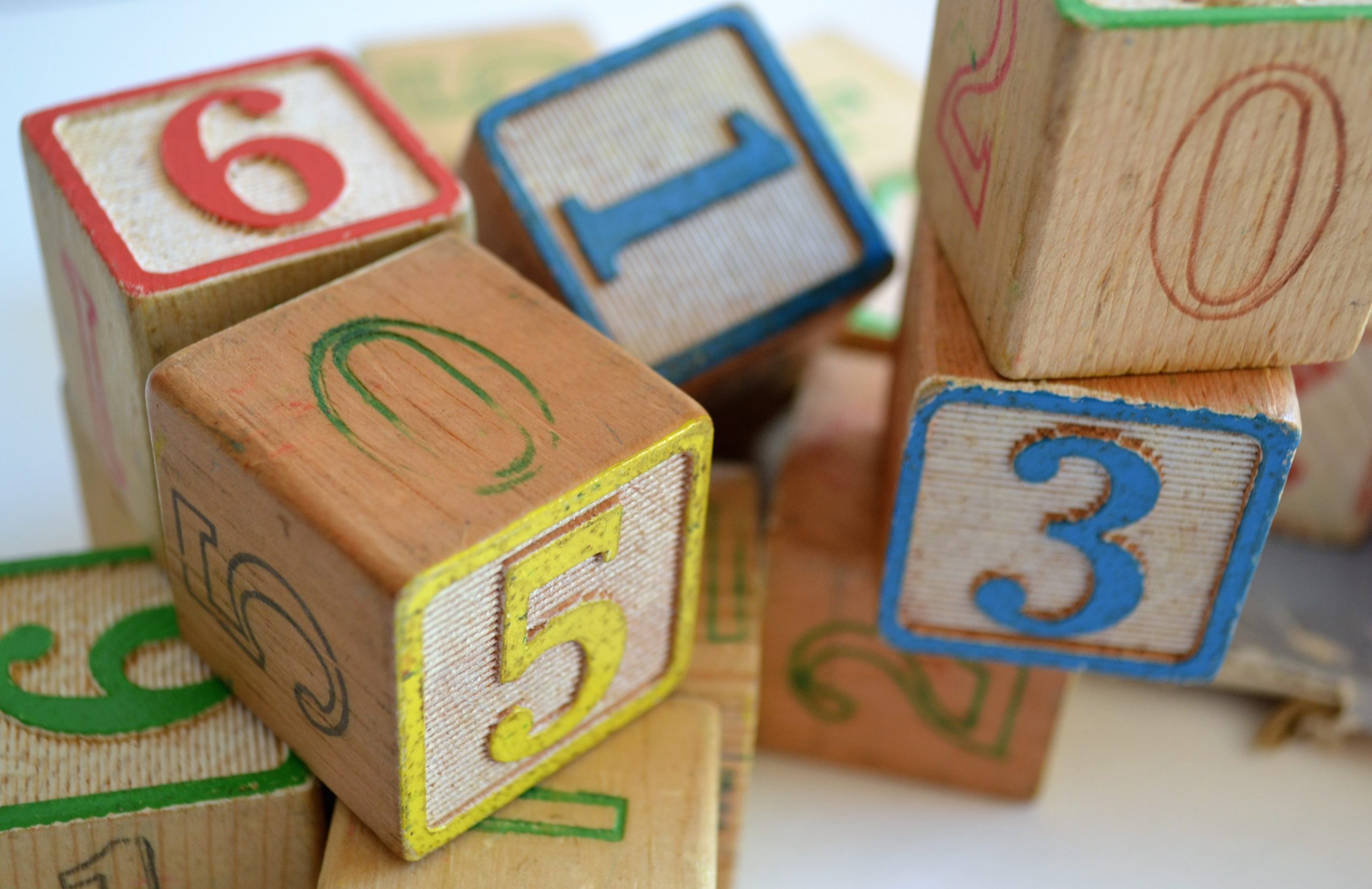 Pile of older style, children's wooden number and ABC blocks